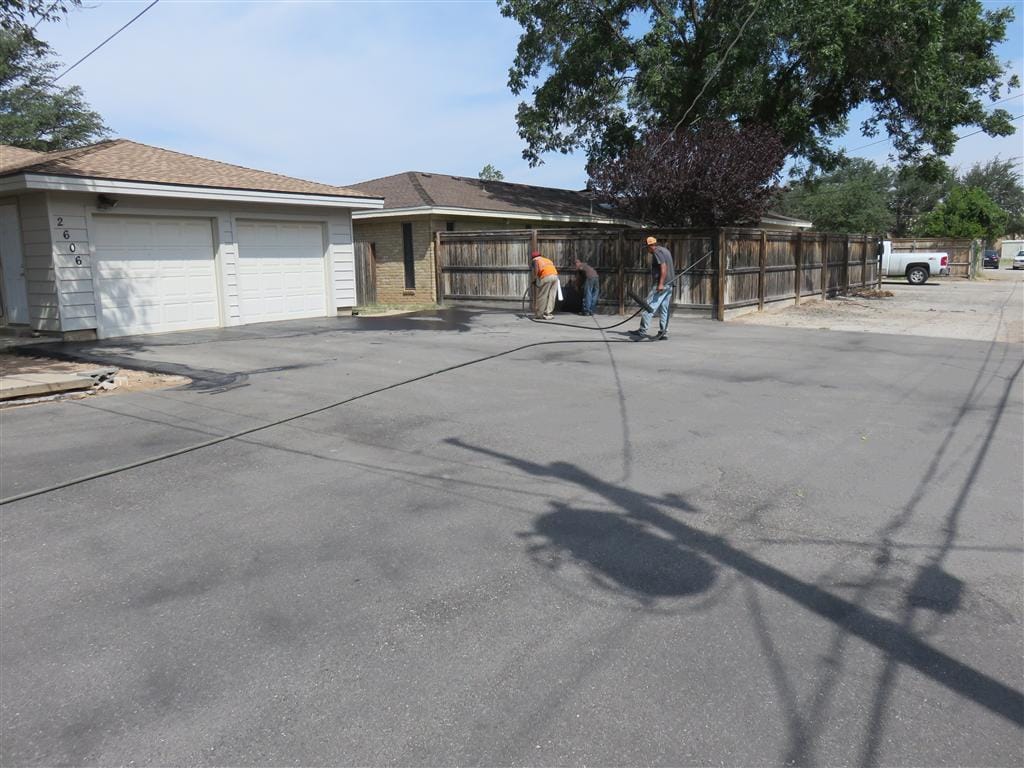 Freshly sealcoated asphalt driveway with deep-black finish